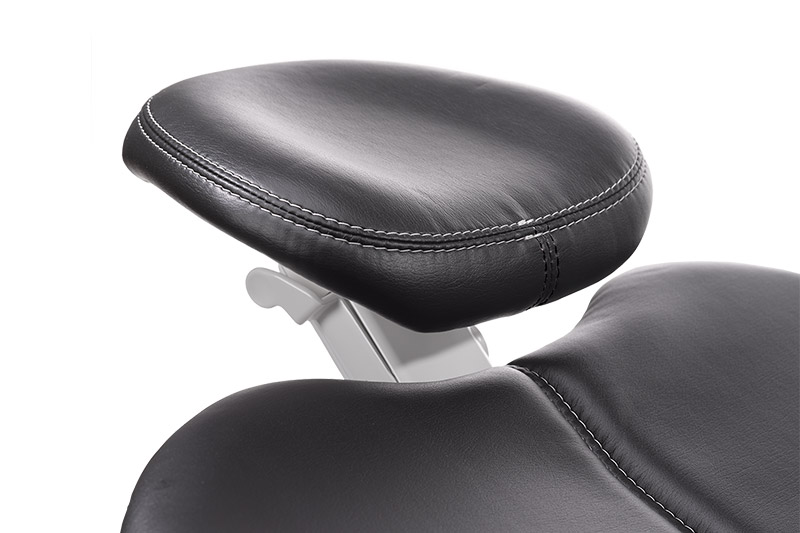 Close-up view of black sewn upholstery on an A-dec dental chair