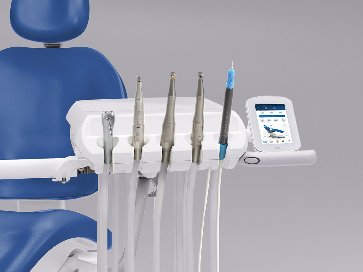 An A-dec 300 Pro delivery system equipped with several dental handpieces and scalers