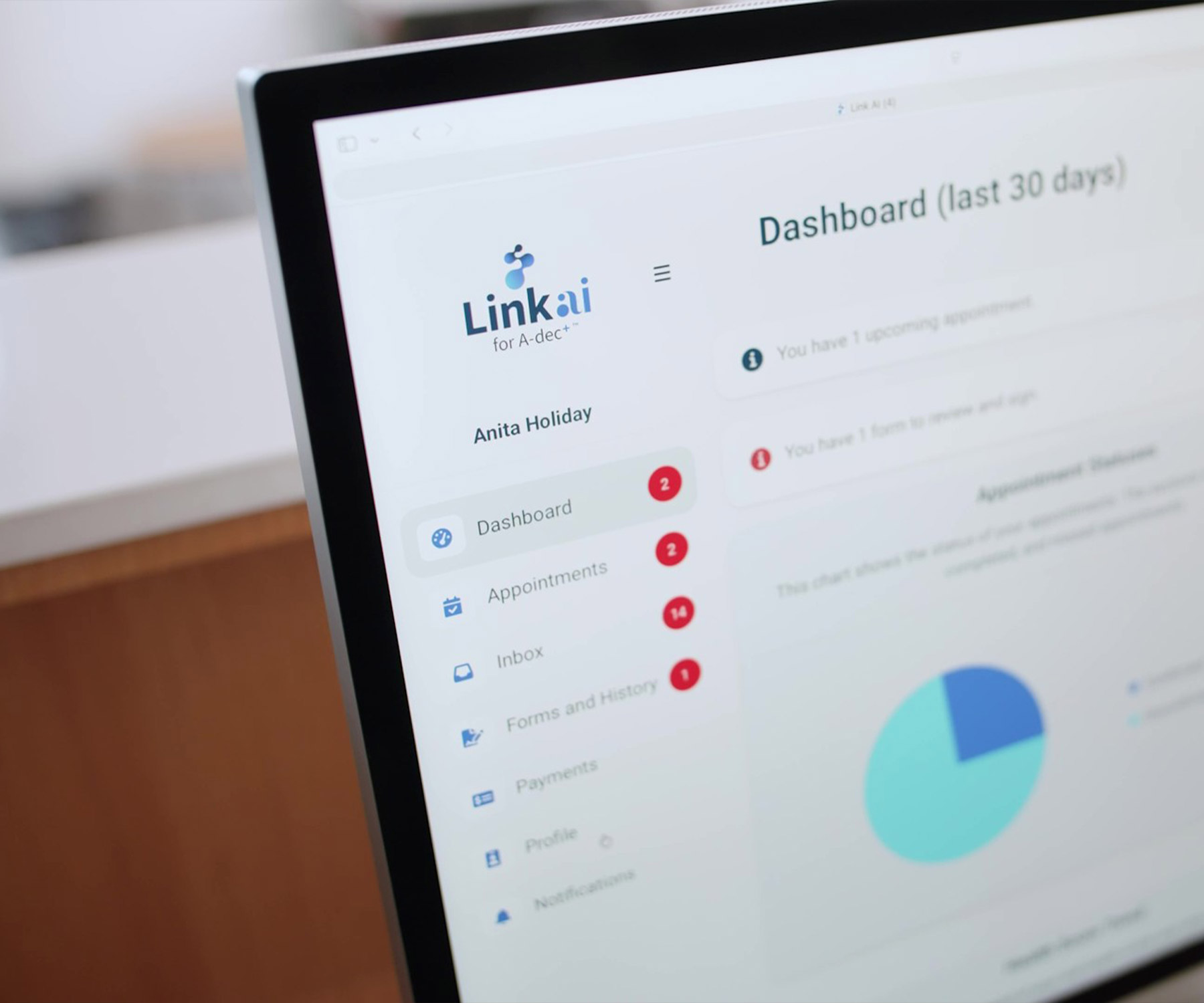 Computer monitor showing dashboards and data from Link AI for A-dec+