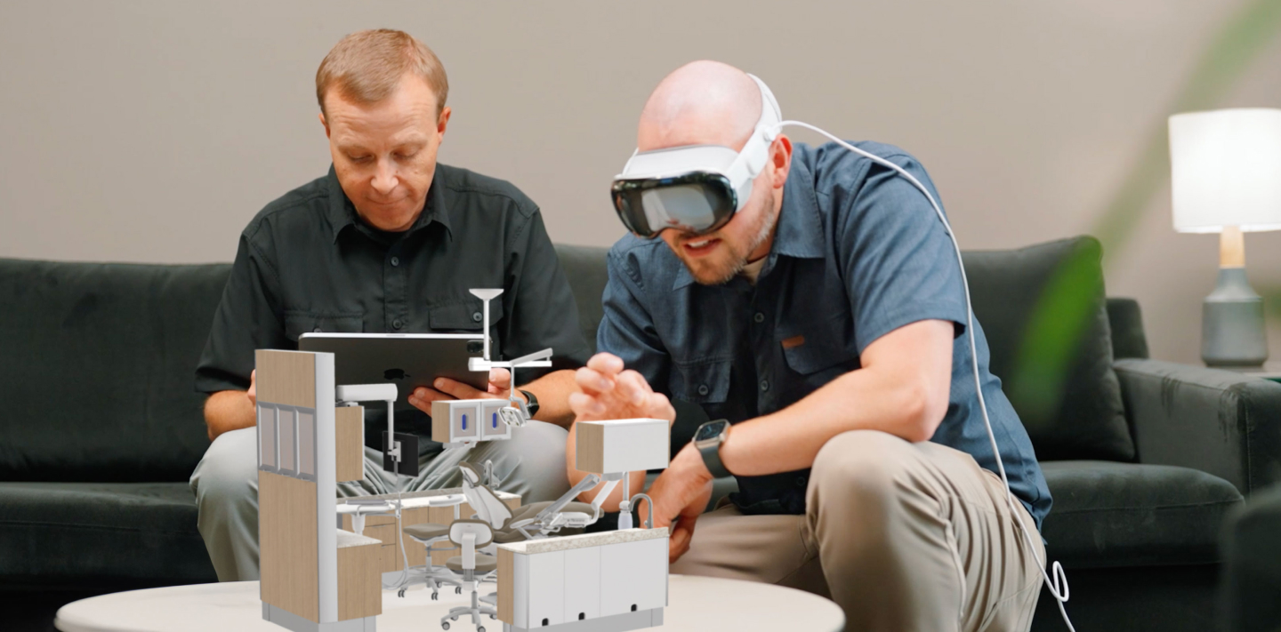 People viewing 3D models of A-dec dental equipment through a VR headset